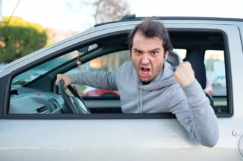 Aggressive driver hanging out the window of his car