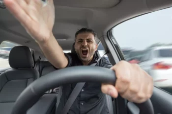 Aggressive man driving a car and shouting